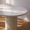 Celestia oval marble dining table with dual fluted cylindrical legs