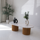 Oval white marble coffee table with cylindrical wooden legs