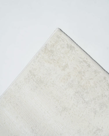 low pile geometric rug under dining table