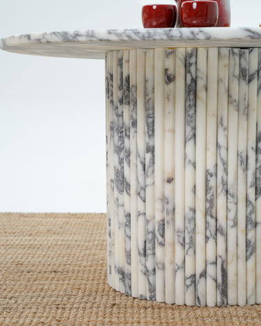 Modern round coffee table with fluted cylindrical marble support