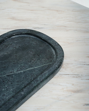 Lumi spider green marble serving tray on stone surface
