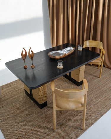 Carin Black Oak Dining Table with Natural Rattan Legs