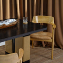 Carin Black Oak Dining Table with Natural Rattan Legs