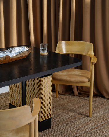 Carin Black Oak Dining Table with Natural Rattan Legs