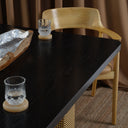Carin Black Oak Dining Table with Natural Rattan Legs