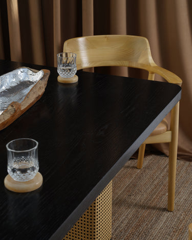 Carin Black Oak Dining Table with Natural Rattan Legs