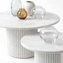 Margot round marble coffee table set with decorative vases, polished White Volakas marble surface with soft grey veining, modern luxury design