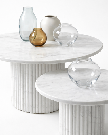 Margot round marble coffee table set with decorative vases, polished White Volakas marble surface with soft grey veining, modern luxury design