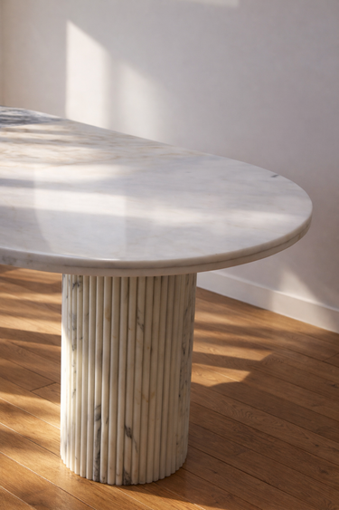Celestia oval marble dining table with dual fluted cylindrical legs