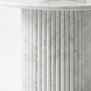 Close-up of Margot marble coffee table fluted cylindrical base in White Volakas marble showing vertical grooves and natural grey veining detail
