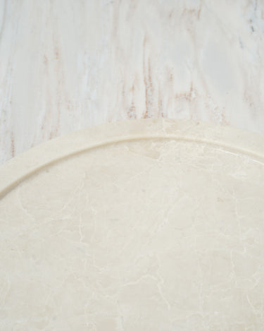 round marble platter placed on stone background