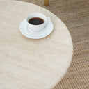 Aurela coffee table with natural travertine texture and curved base