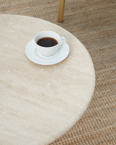Aurela coffee table with natural travertine texture and curved base