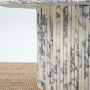 Modern round coffee table with fluted cylindrical marble support