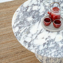Contemporary round marble coffee table with sculptural base