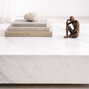 Althea White Volakas marble coffee table styled with books and decor, showcasing polished surface and natural stone veining
