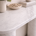 Detail of Evelyn console table surface in White Volakas marble showing soft grey veining and refined curved edge finish
