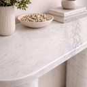 Evelyn White Volakas marble console table top styled with decor, highlighting smooth oval edges and polished stone surface