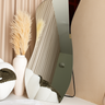 Solis frameless irregular standing mirror with sculptural shape in modern interior
