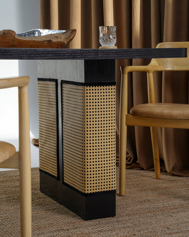 Carin Black Oak Dining Table with Natural Rattan Legs