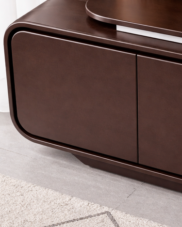 Modern brown entertainment console with a plant on top in a minimalistic room.